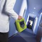ZOLL AED 3 Fully Automatic Defibrillator - lifestyle shot, showing the AED being carried to an emergency