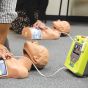 ZOLL AED 3® Trainer - lifestyle shot, showing it being used on an AED Demo Manikin