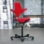 HÅG Capisco Puls 8020 Ergonomic Office Chair - lifestyle shot, showing the red chair with a black base