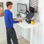 JOSHO Homeworker Electric Sit-Stand Desk - lifestyle shot - white desk and frame, side angle view, showing standing position