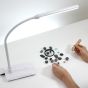 Daylight Company UnoLamp Table - lifestyle shot, showing jewellery making