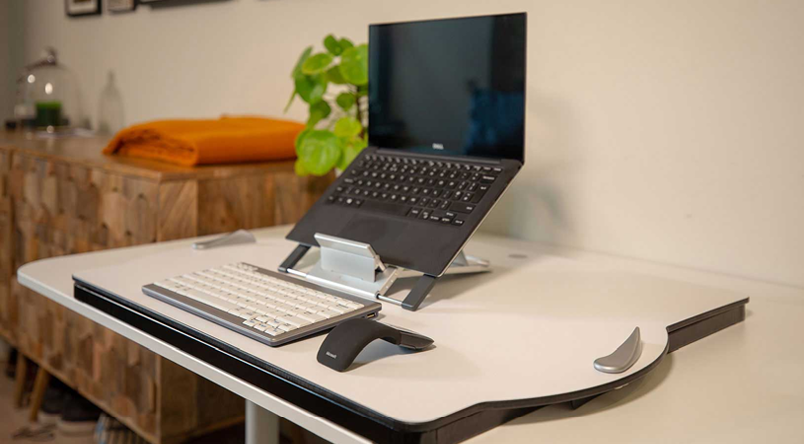 Laptop with laptop stand and computer accessories placed on the flat version of the Oploft Sit-Stand Platform